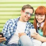 couple-with-phones-feed_shutterstock