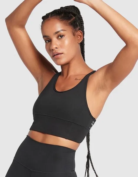 Model wearing black Nimble Activewear sports bra against a white background.