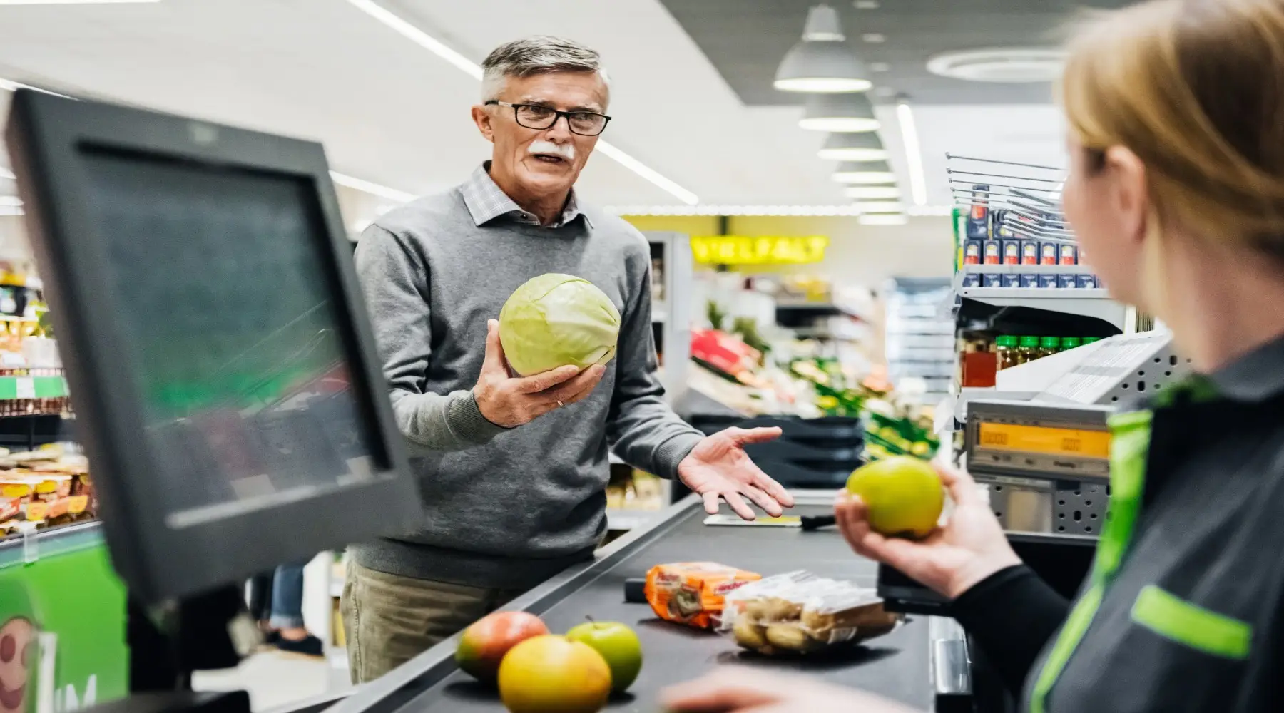 Man talking to cashier_GettyImages_1800x1000