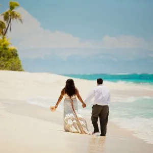 Couple holding hands on a Fiji beach