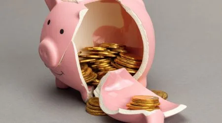Pink piggy bank with gold coins inside