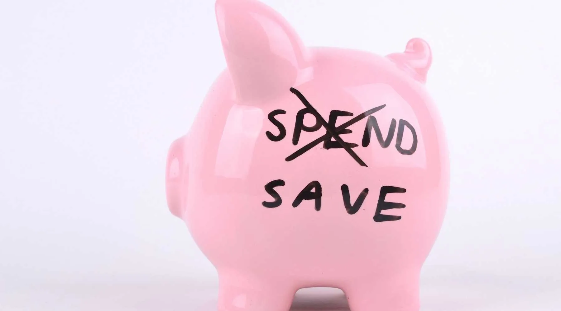 Spend less piggy bank_Canva_1800x1000