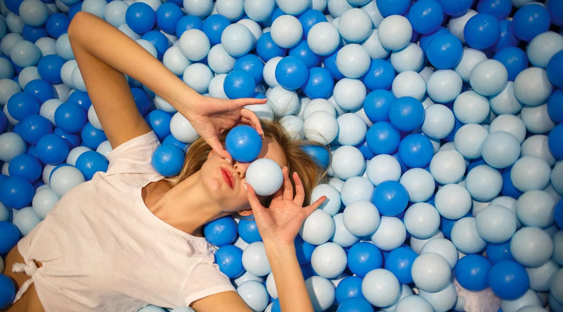 Woman in a blue and white ball pit