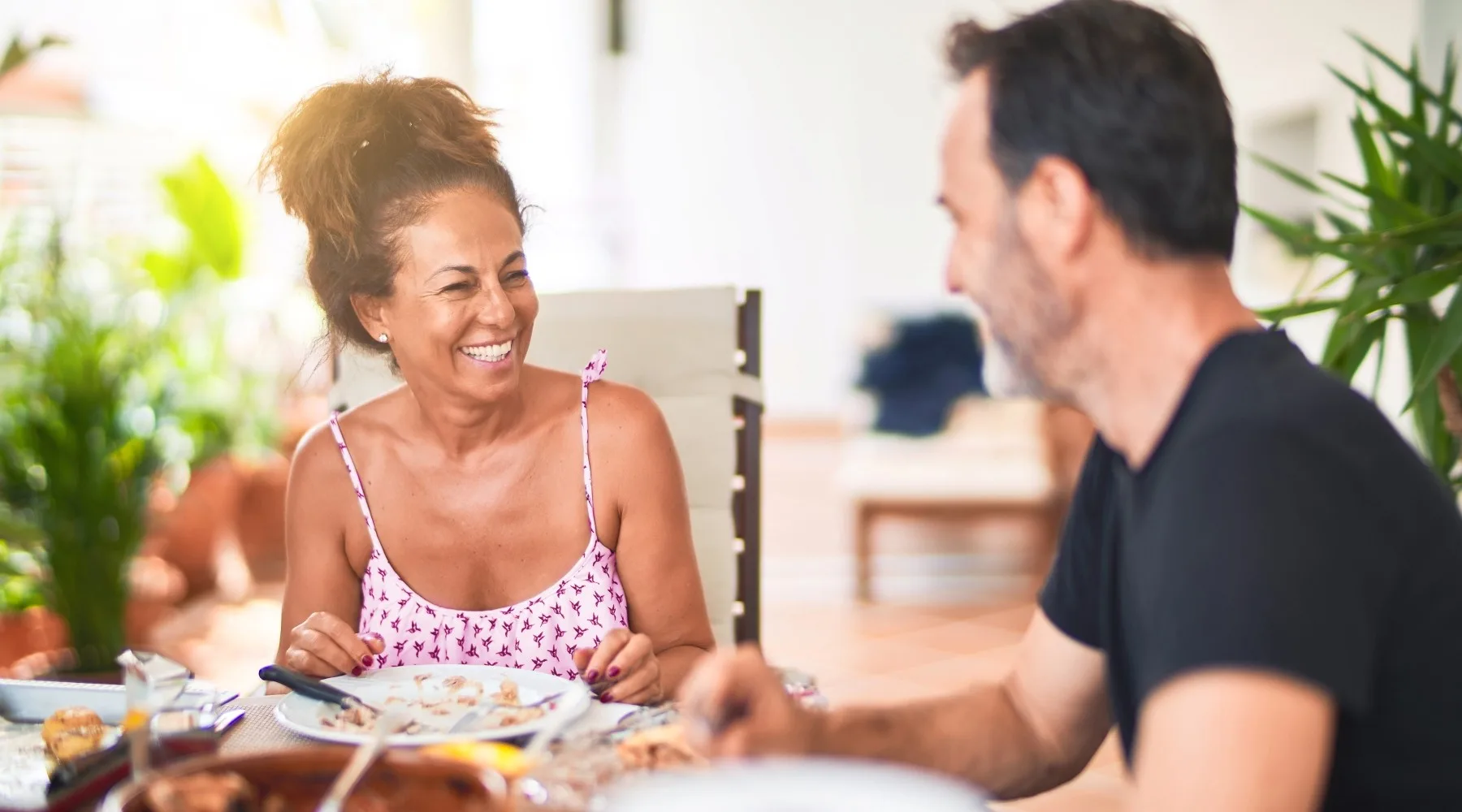 A middle-aged couple eating dinner together