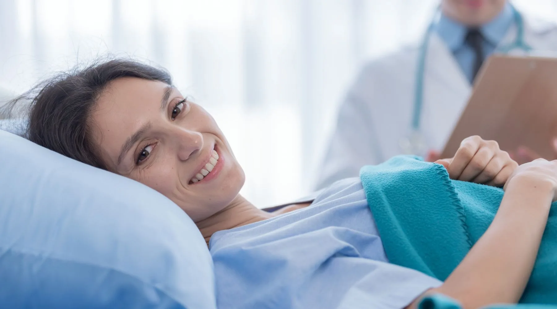 Happy_Woman_Lying_Hospital_Bed_Canva_1800x1000 Happy_Woman_Lying_Hospital_Bed_Canva_1800x1000