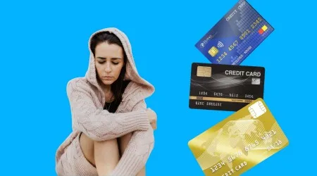 Woman looking stressed with credit cards.