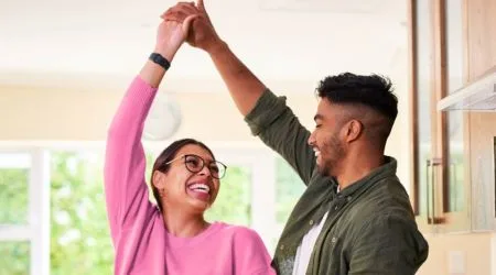A young couple dancing in their kitchen 