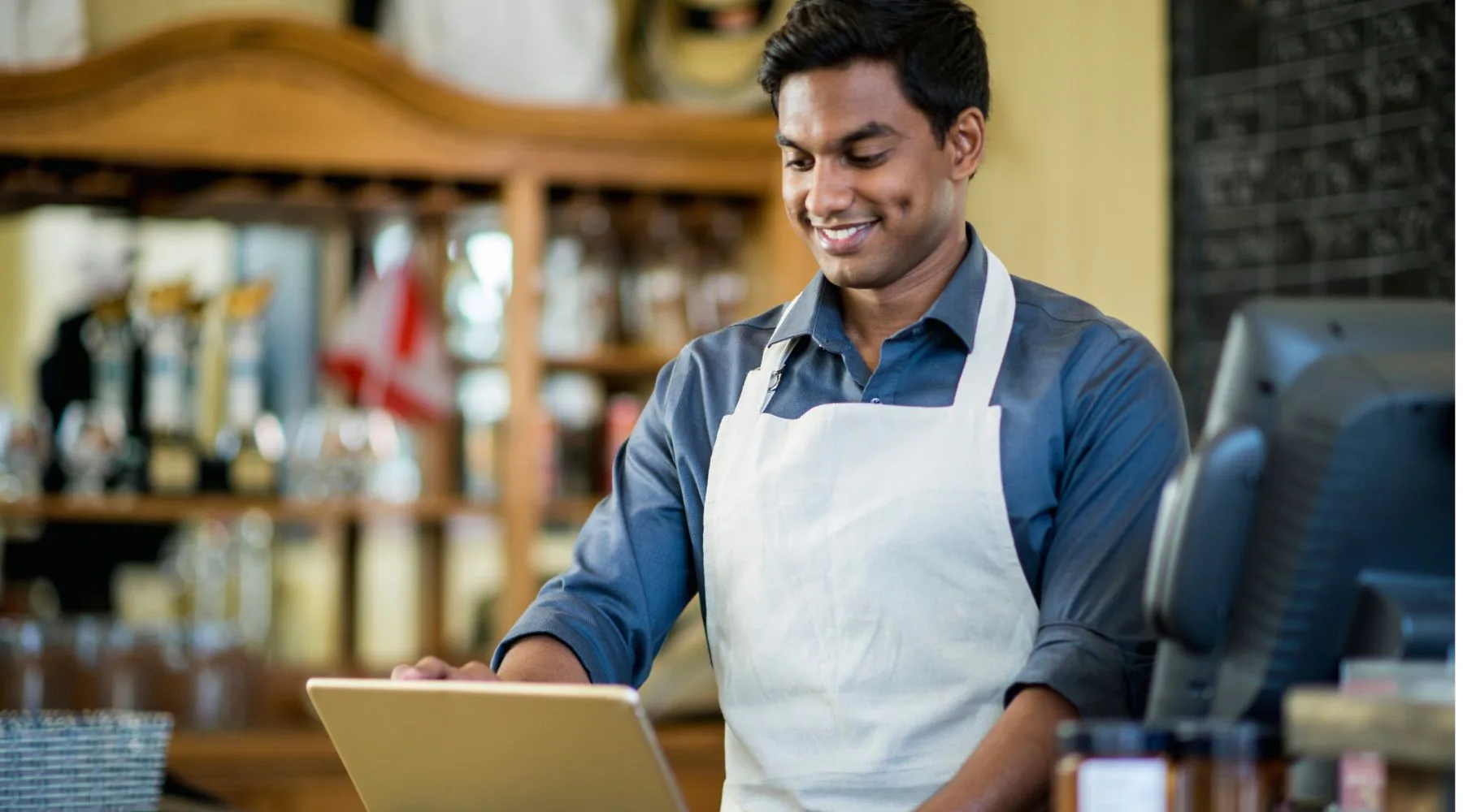 Small_Business_Owner_Running_POS_Canva_1800x1000 Small_Business_Owner_Running_POS_Canva_1800x1000