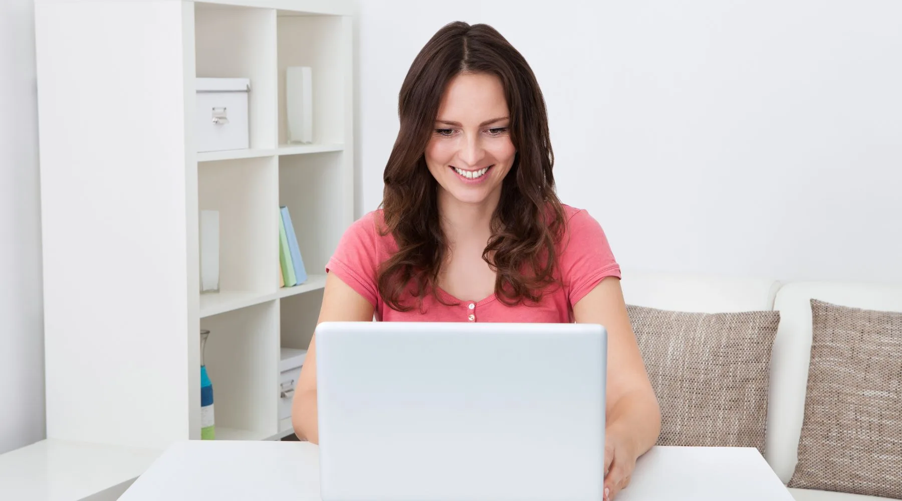 Woman_Checking_Savings_On_Her_Laptop_Canva_1800x1000