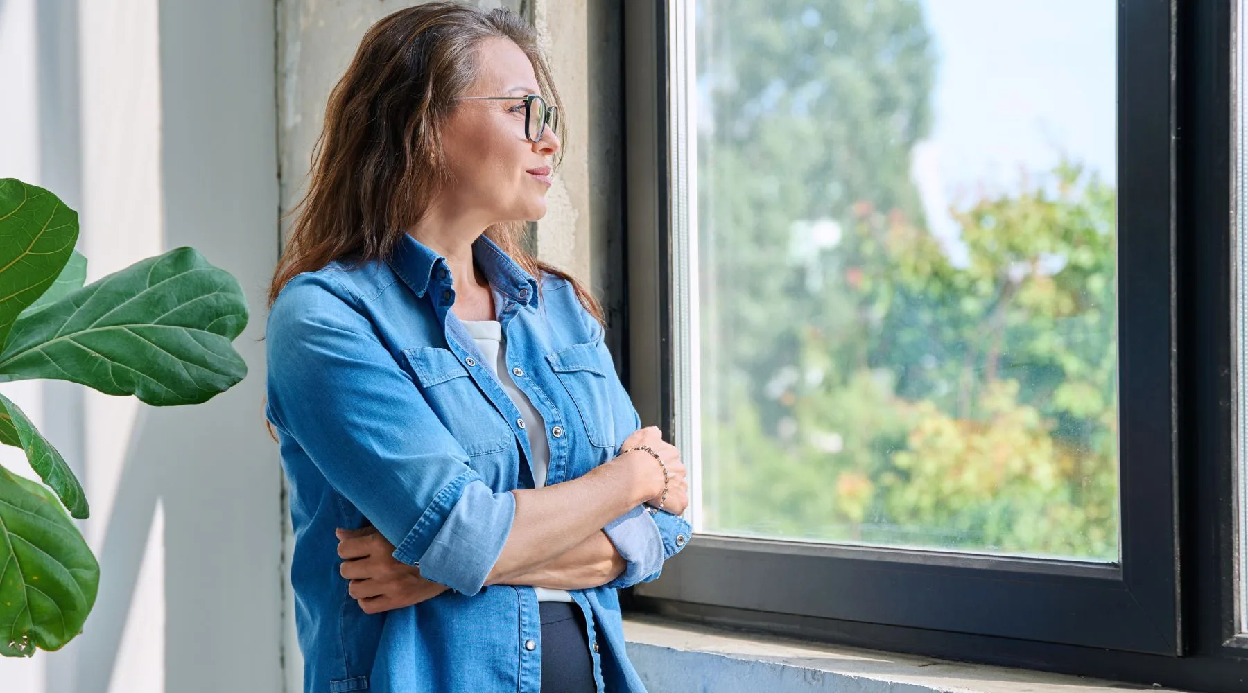Middle_Aged_Woman_Looking_Out_Window_Canva_1800x1000 Middle_Aged_Woman_Looking_Out_Window_Canva_1800x1000