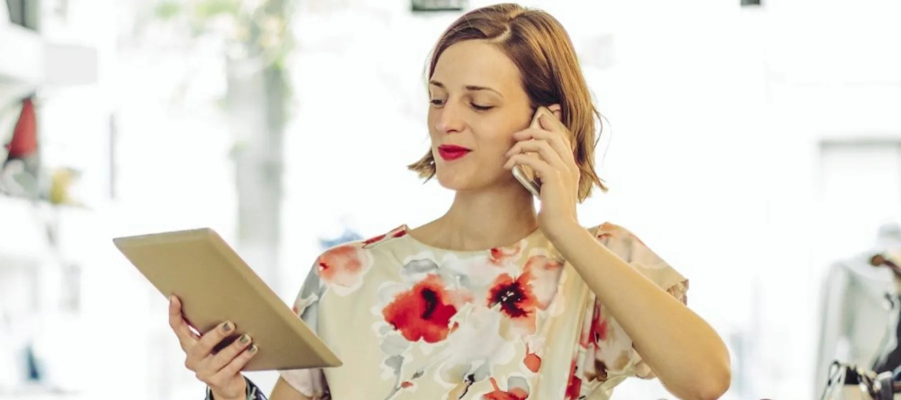 A small business owner on a phone and tablet 