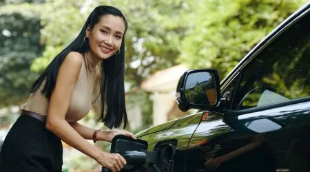 A woman charging her electric car. 
