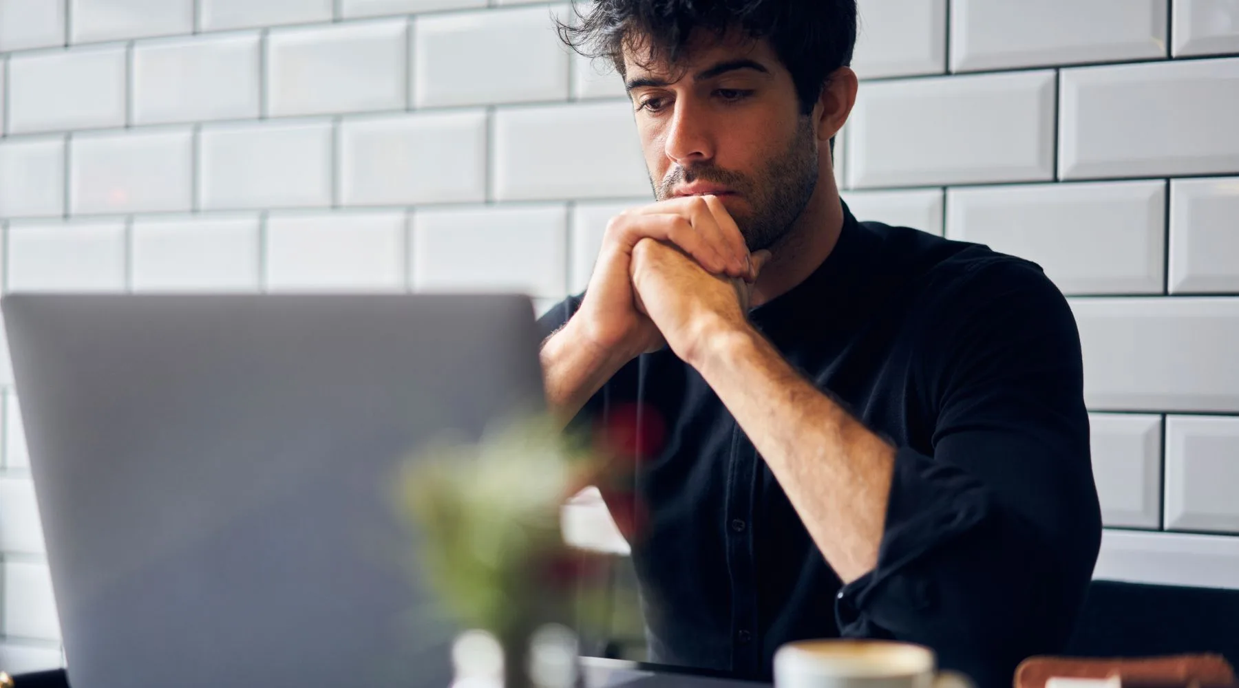 Thoughtful_Man_On_Laptop_Canva_1800x1000