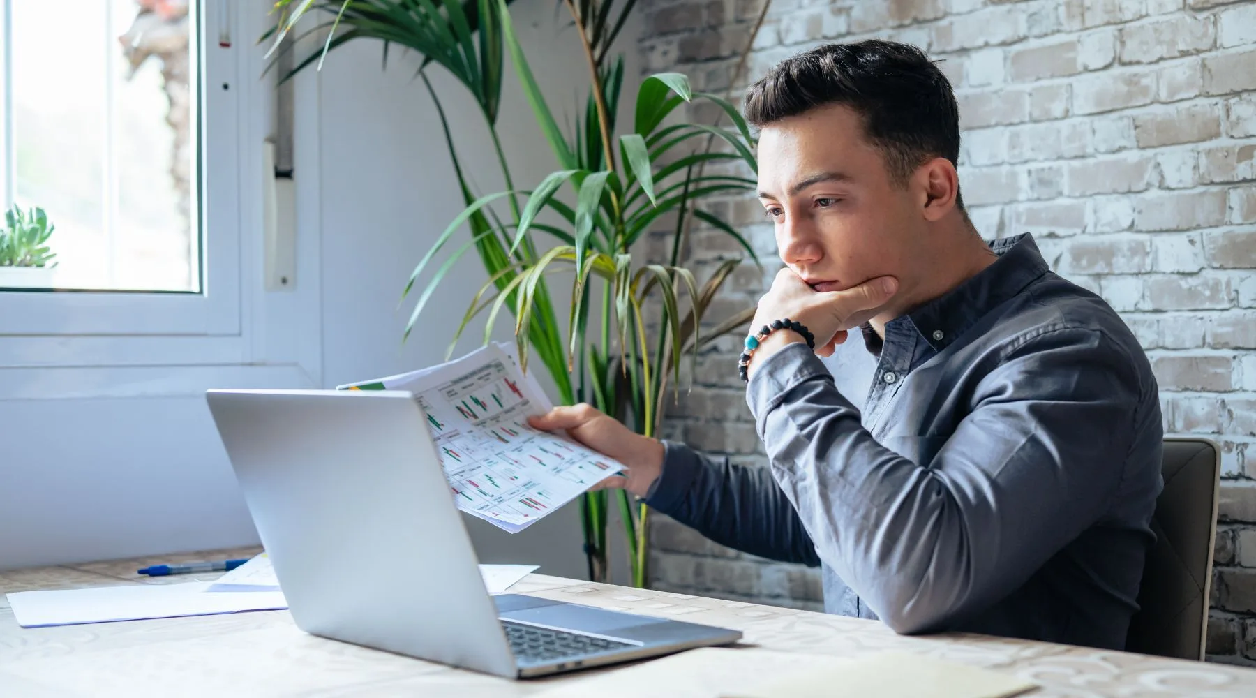 Crypto_Investor_Looking_At_Laptop_And_Charts_Canva_1800x1000 Crypto_Investor_Looking_At_Laptop_And_Charts_Canva_1800x1000