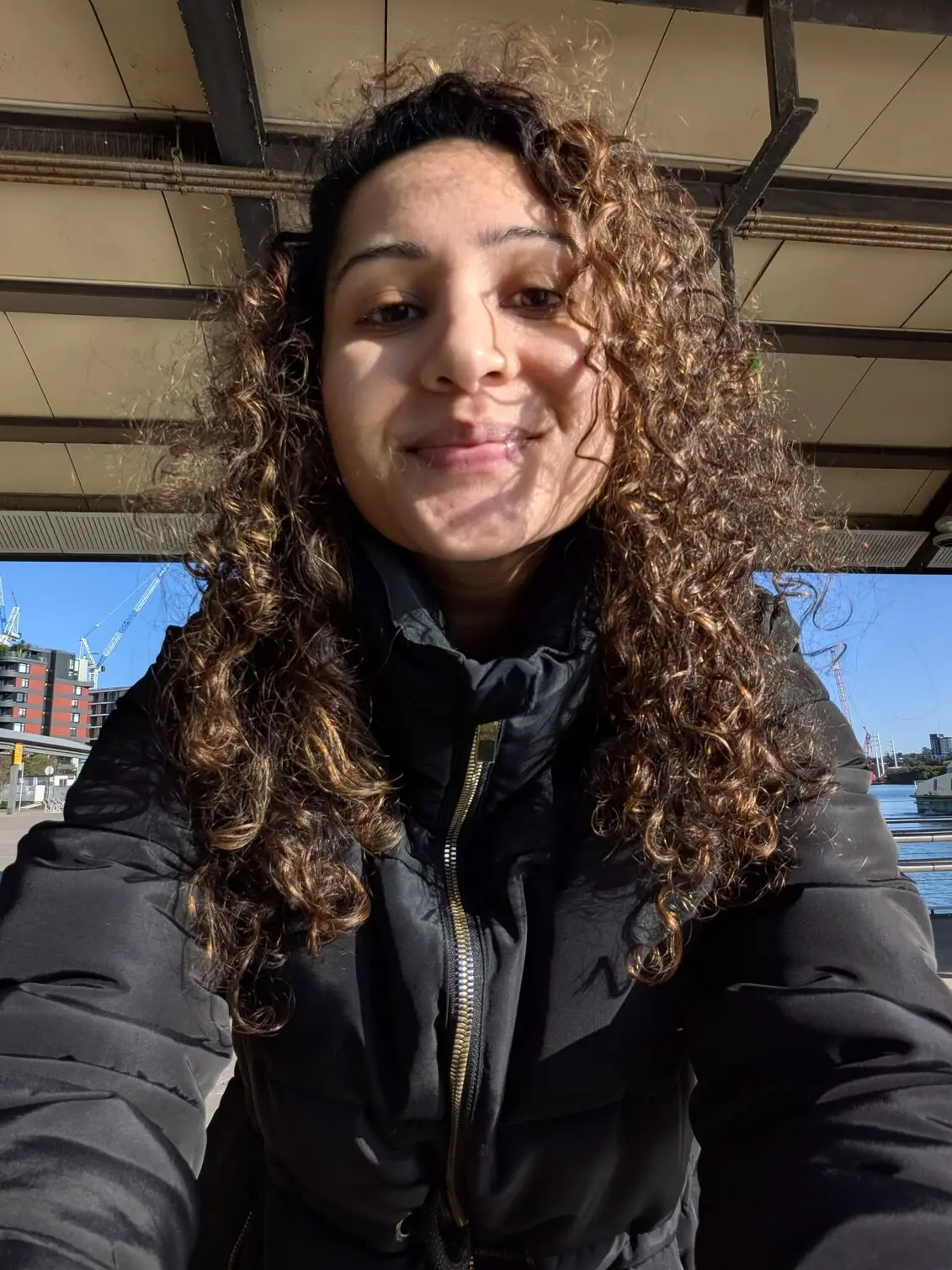 A selfie taken using the Google Pixel 10a showing natural skin tones and sharp detail under bright outdoor lighting.