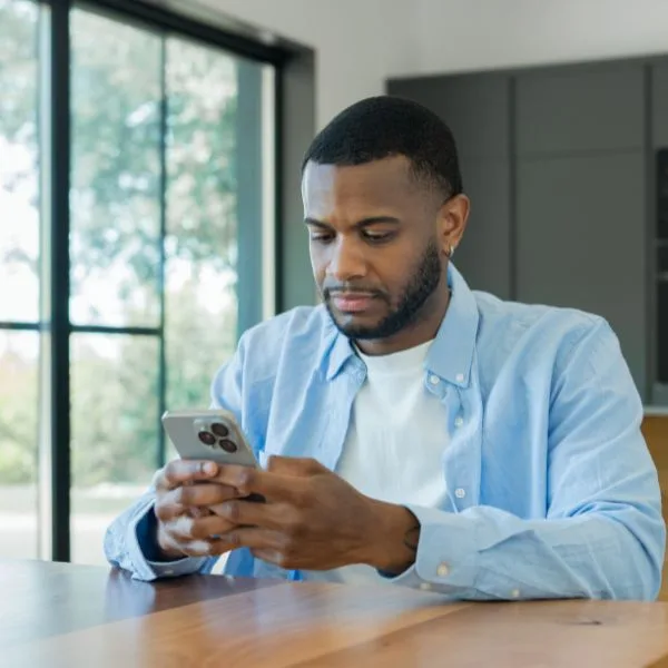 Image: Canva Trading online with a phone