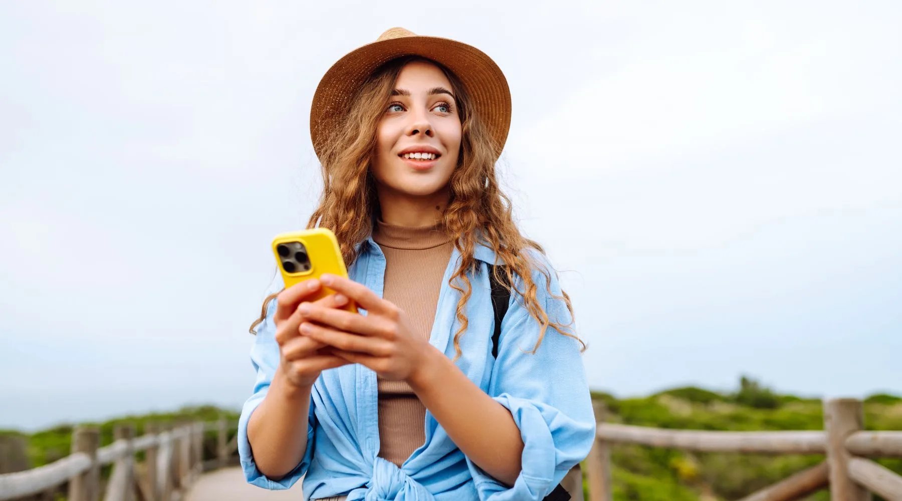 Woman_In_Hat_Travelling_On_Phone_Canva_18000x1000 Woman_In_Hat_Travelling_On_Phone_Canva_18000x1000