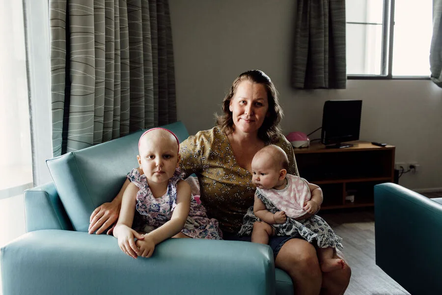 A mother with two children on a couch