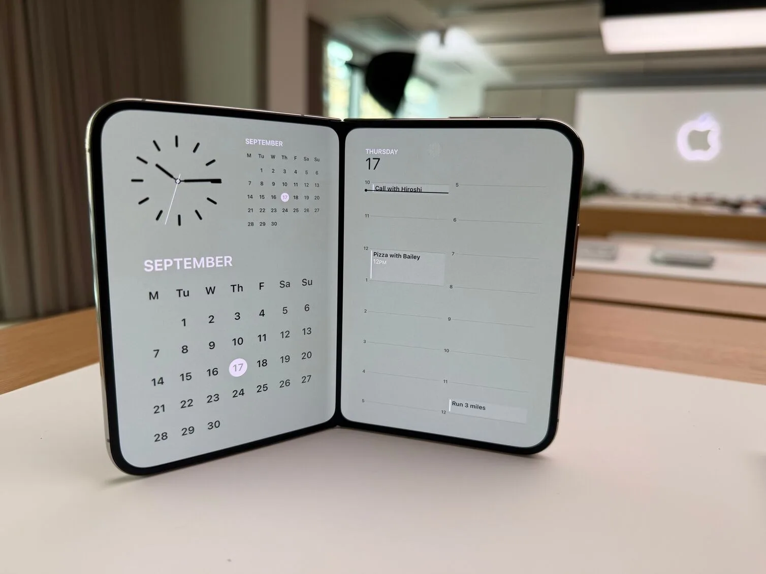 Image: Mariam Gabaji/Finder iPhone Duo propped open, two displays split between a clock-and-calendar view and a daily schedule.