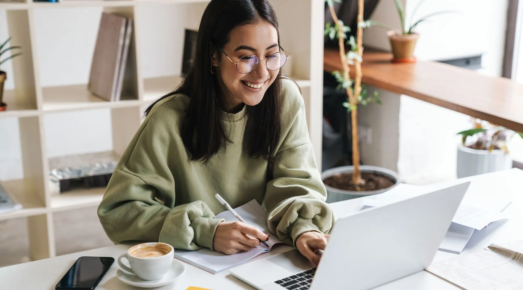 Woman_Using_Laptop_Drinking_Coffee_Canva
