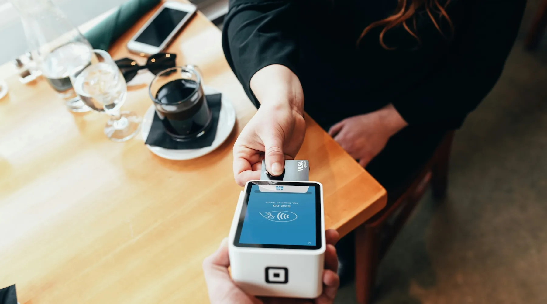 Woman paying with credit card_Unsplash_1800x1000