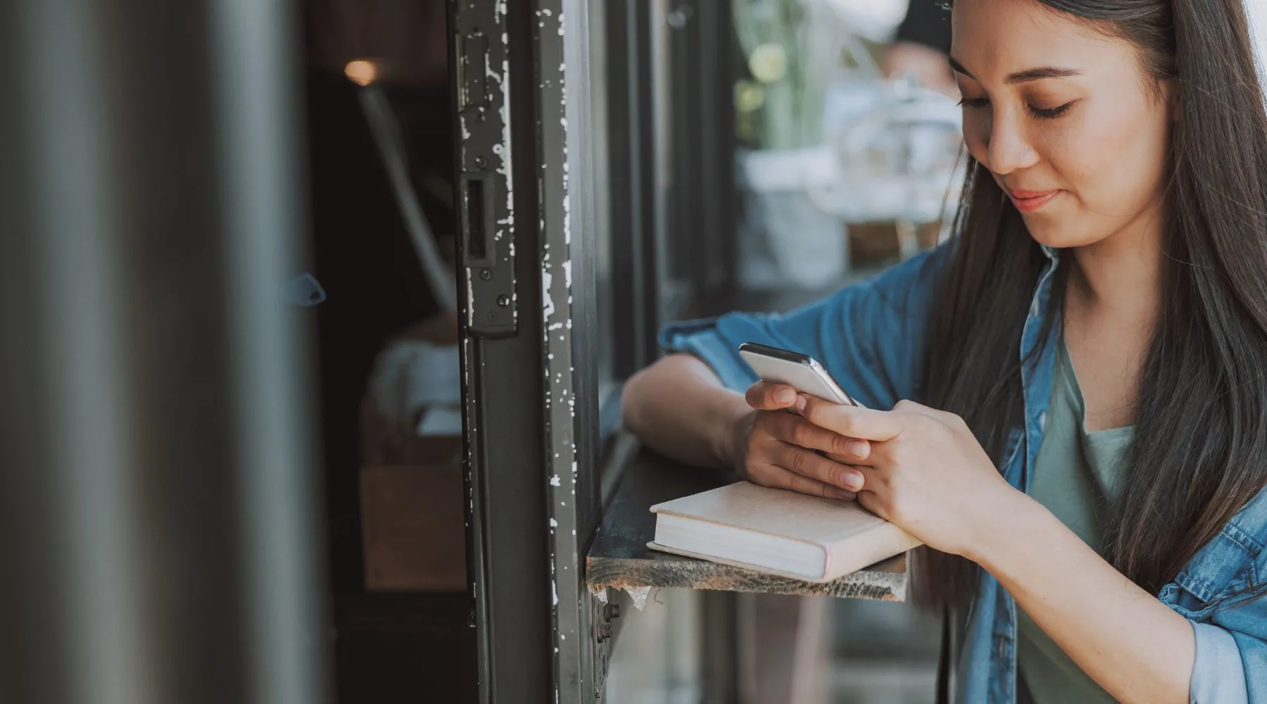 Young_Woman_Using_Mobile_At_Cafe_Canva_1800x1000