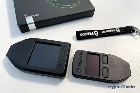 Trezor Model T and Model One on tabletop with accessories