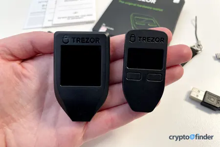 Trezor Model T and Model One held in a hand
